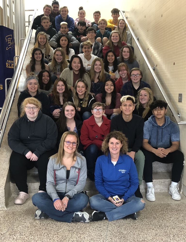 EAHS students and teachers sitting on staircase