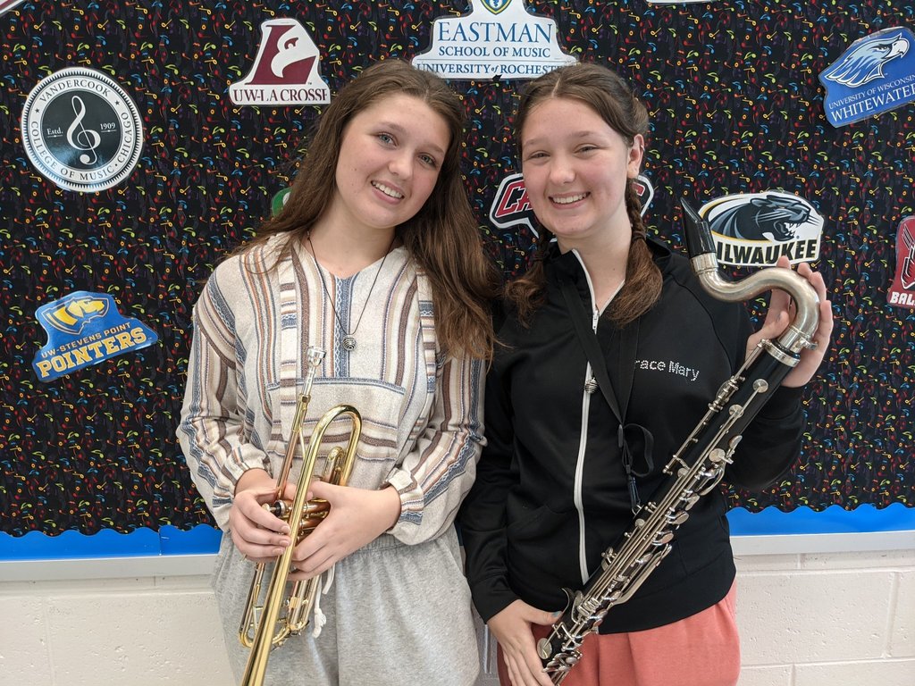 Anna and Grace posing with their musical instruments