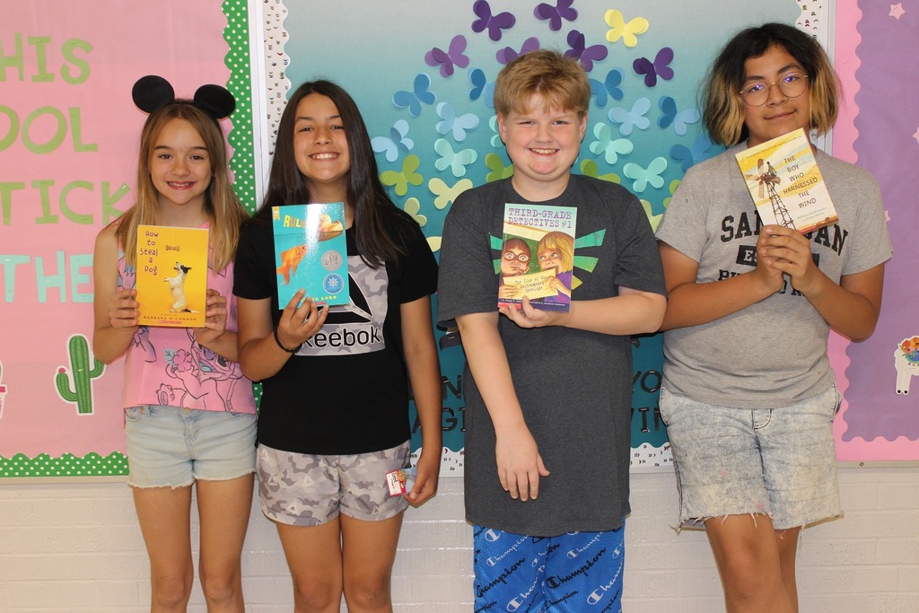 West Side students posing with books