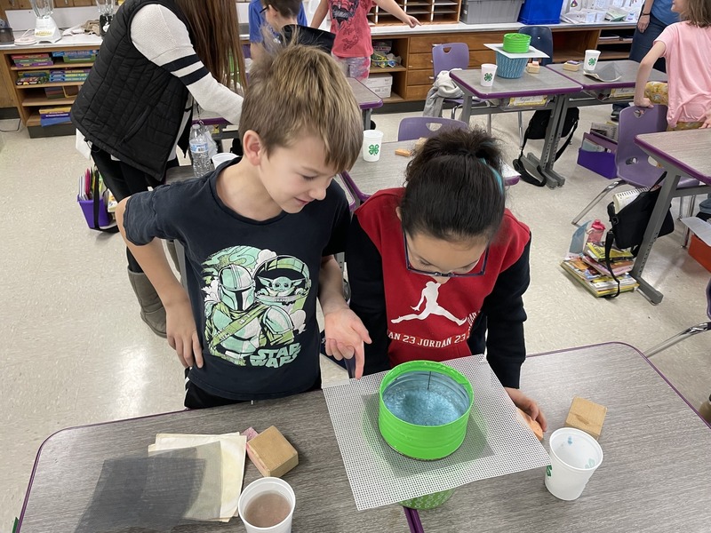 Elementary students performing a science experiment