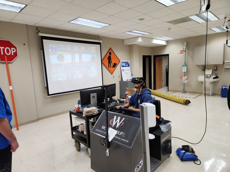 CCA student tries out a construction vehicle simulator