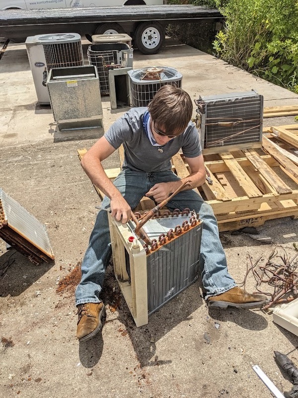 Sebastian Coy working on AC unit